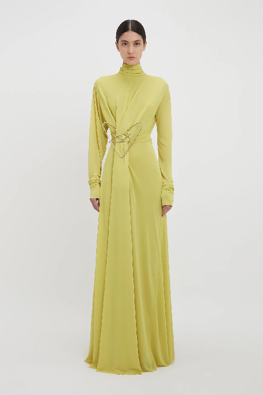 Women in a long sleeve gown in yellow