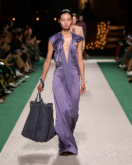 Women in purple maxi dress on the runway 