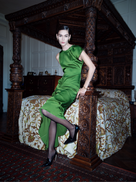 Women in green pleat detail midi dress