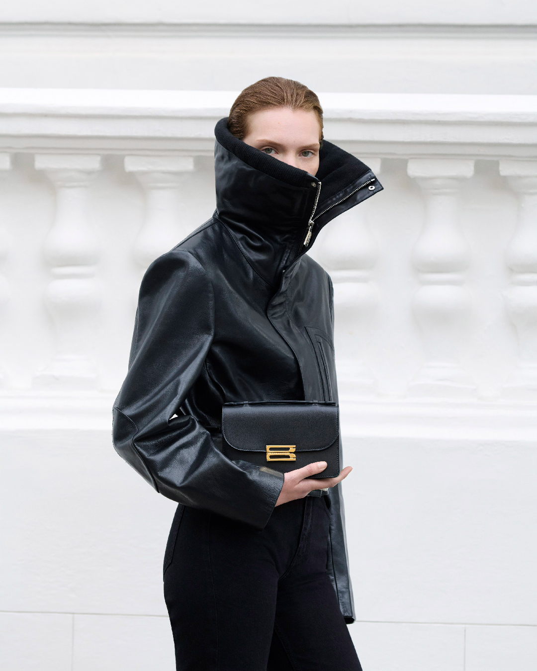 Women in cropped black leather biker jacket 