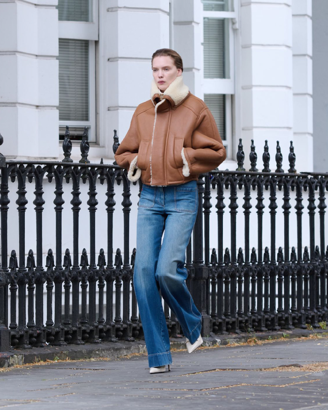 Women in tan cropped jacket with fur detail 
