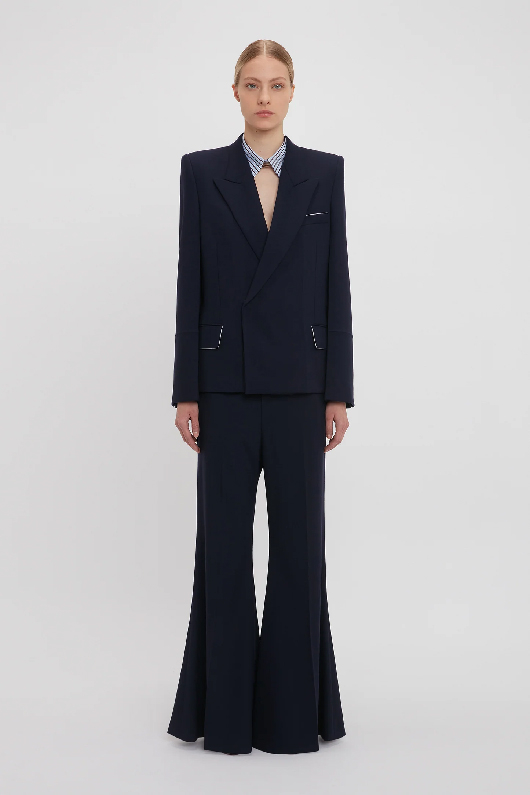 Women in dark blue blazer and wide leg trousers 