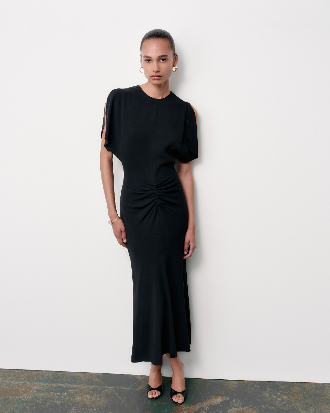 Women in black gathered waist dress