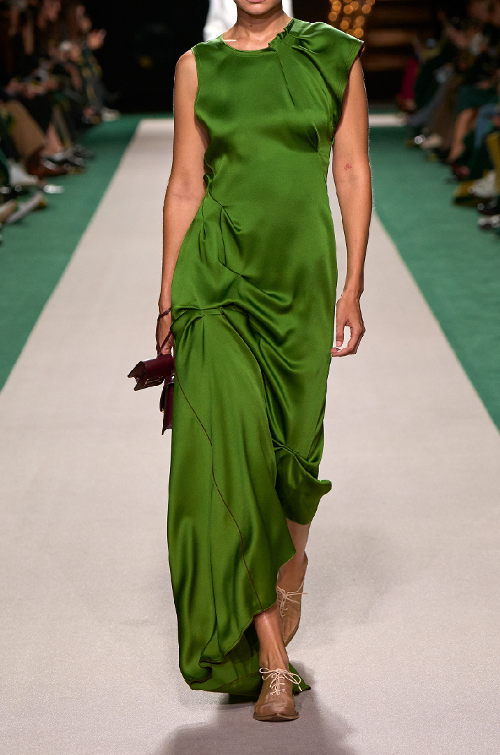 Women in green pleat detail midi dress