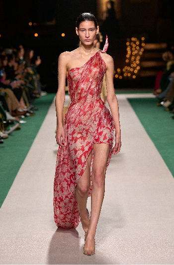 Women in a red floral pattered gathered bodice dress 