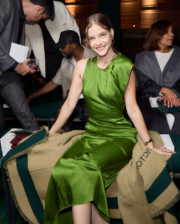 Women in green draped midi dress 