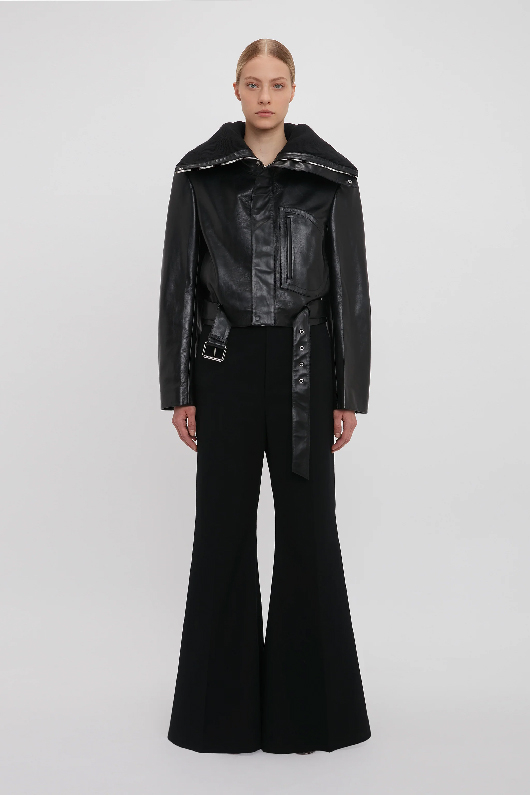Women in cropped black leather biker jacket 