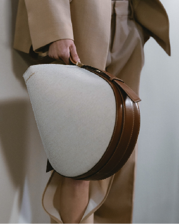 A light brown medium bag with a darker brown panel 
