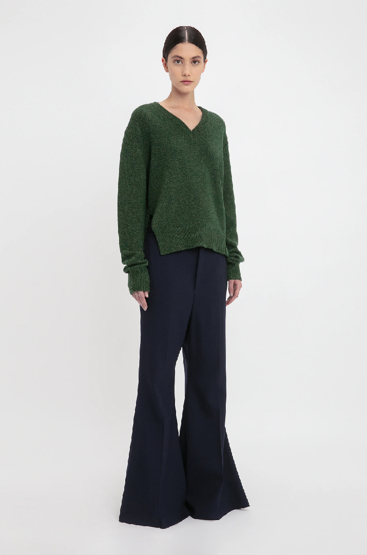 Women in green v-neck jumper 