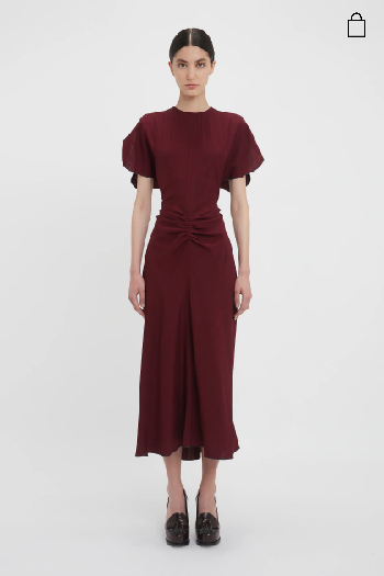 Women in burgundy gathered waist midi dress