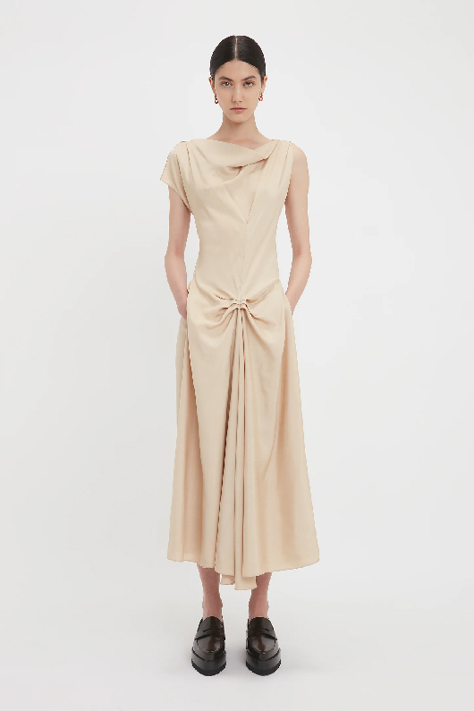 Women in a light pink gathered mdi dress