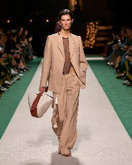 Women in light brown suit on the runway 