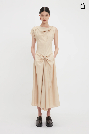Women in light pink gathered waist dress